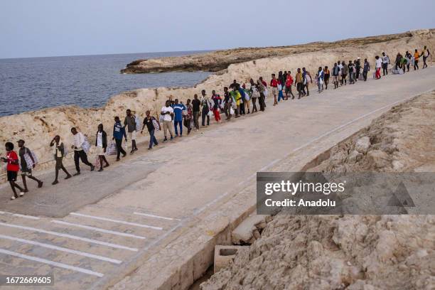 Migrants are seen before embarking the Lampedusa Ferry as the massive transfer of migrants is taking place from the Sicilian island of Lampedusa to...