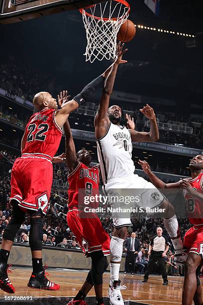 Andray Blatche of the Brooklyn Nets shoots against Taj Gibson of the Chicago Bulls in Game Two of the Eastern Conference Quarterfinals during the...