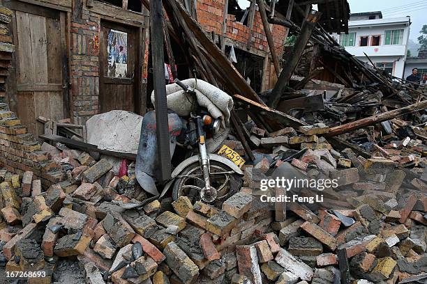 Motorcycle and rubble from a collapsed building after a strong earthquake hit Southwest China's Sichuan Province on April 23, 2013 in Longmen...