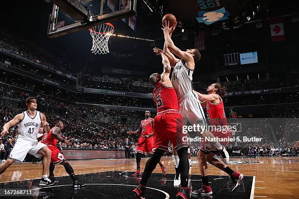 Brook Lopez of the Brooklyn Nets shoots against Carlos Boozer of the Chicago Bulls in Game Two of the Eastern Conference Quarterfinals during the...