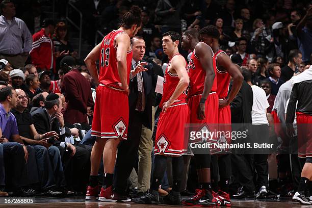 Tom Thibodeau of the Chicago Bulls speaks with his team during a time out against the Brooklyn Nets in Game Two of the Eastern Conference...