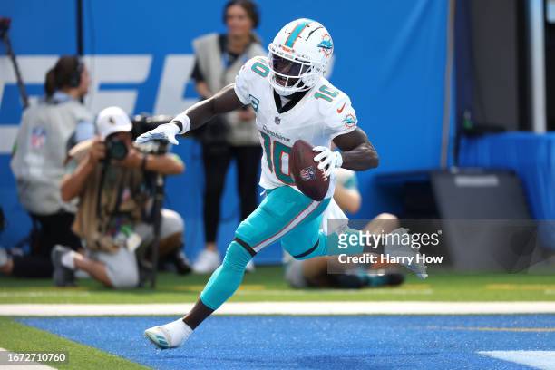 Tyreek Hill of the Miami Dolphins scores a touchdown in the third quarter of a game against the Los Angeles Chargers at SoFi Stadium on September 10,...