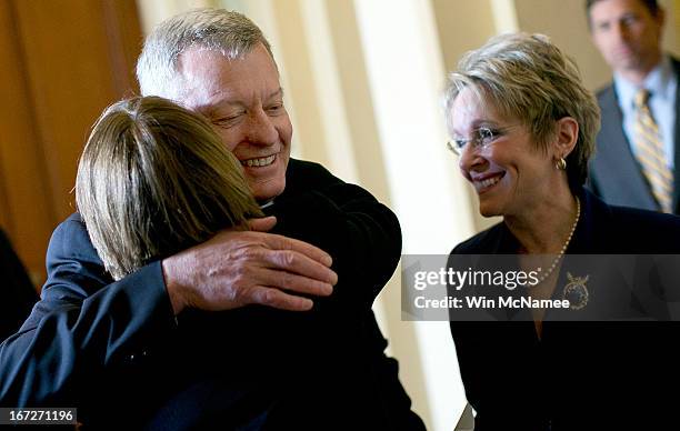 Sen. Max Baucus is hugged by Sen. Amy Klobuchar while walking with his wife Melodee Hanes at the U.S. Capitol April 23, 2013 in Washington, DC. It...