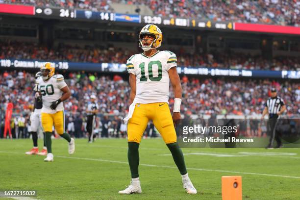 Jordan Love of the Green Bay Packers celebrates a touchdown pass to Romeo Doubs against the Chicago Bears during the second half at Soldier Field on...