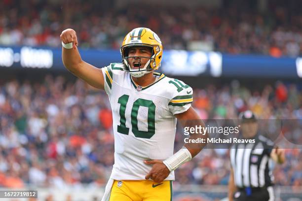 Jordan Love of the Green Bay Packers celebrates a touchdown pass to Romeo Doubs against the Chicago Bears during the second half at Soldier Field on...