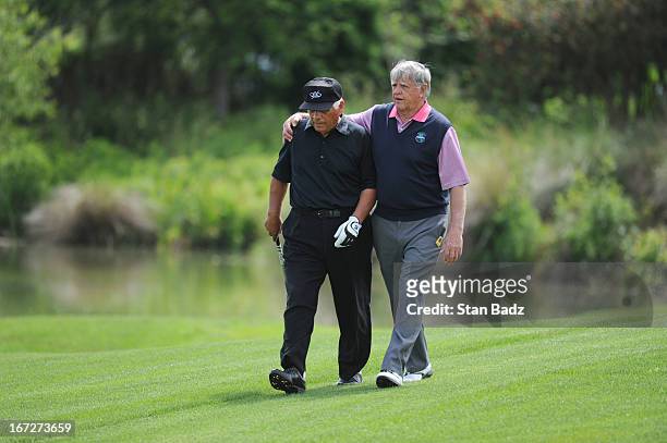 Lee Trevino and Mike Hill walk to the 17th green during the final round of the Demaret Division at the Liberty Mutual Insurance Legends of Golf at...