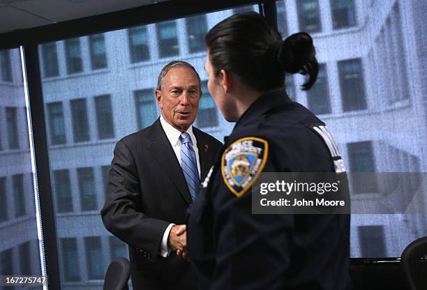 New York City Mayor Michael Bloomberg greets a counter-terrorism police officer at the Lower Manhattan Security Initiative on April 23, 2013 in New...