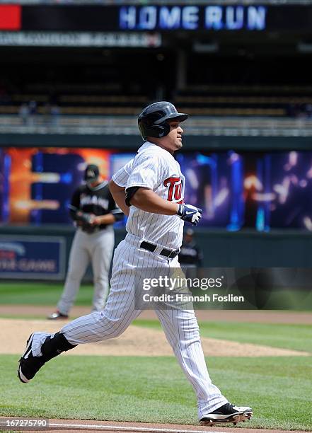 Oswaldo Arcia of the Minnesota Twins rounds the bases after hitting three run home run as Jose Fernandez of the Miami Marlins looks on during the...