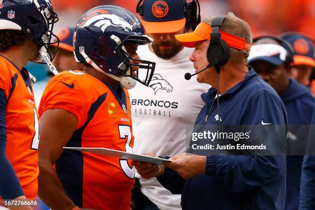 Russell Wilson of the Denver Broncos talks to head coach Sean Payton of the Denver Broncos during the second quarter against the Las Vegas Raiders at...