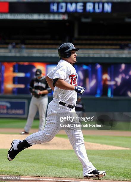 Oswaldo Arcia of the Minnesota Twins rounds the bases after hitting a three-run home run as Jose Fernandez of the Miami Marlins looks on during the...
