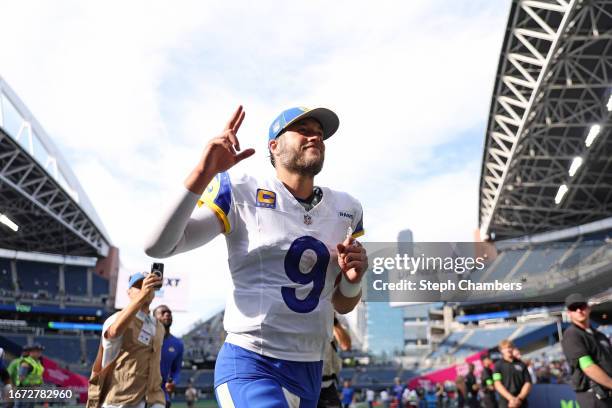 Matthew Stafford of the Los Angeles Rams celebrates as he runs off the field following the 30-13 win against the Seattle Seahawks at Lumen Field on...