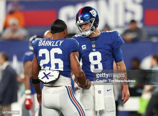 Daniel Jones and Saquon Barkley of the New York Giants talk during warmups prior to a game against the Dallas Cowboys at MetLife Stadium on September...