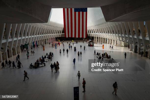 People walk through the Westfield World Trade Center, also known as the Oculus, near the 9/11 Memorial and Museum at the Ground Zero site in lower...