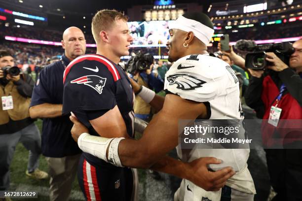 Mac Jones of the New England Patriots and Jalen Hurts of the Philadelphia Eagles talk after Philadelphia's 25-20 win at Gillette Stadium on September...