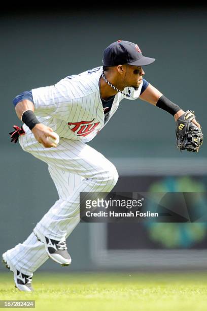 Pedro Florimon of the Minnesota Twins makes a play at shortstop for an out during the eighth inning of the first game of a doubleheader against the...