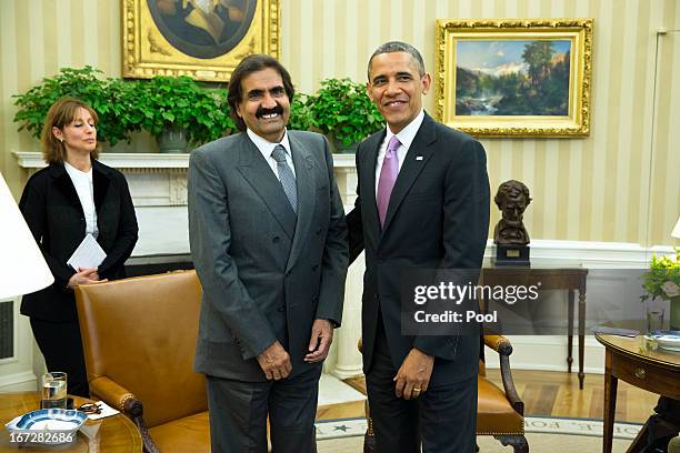 President Barack Obama poses with the Emir of Qatar, Hamad bin Khalifa al-Thani during a presser in the Oval Office of the White House April 23, 2013...