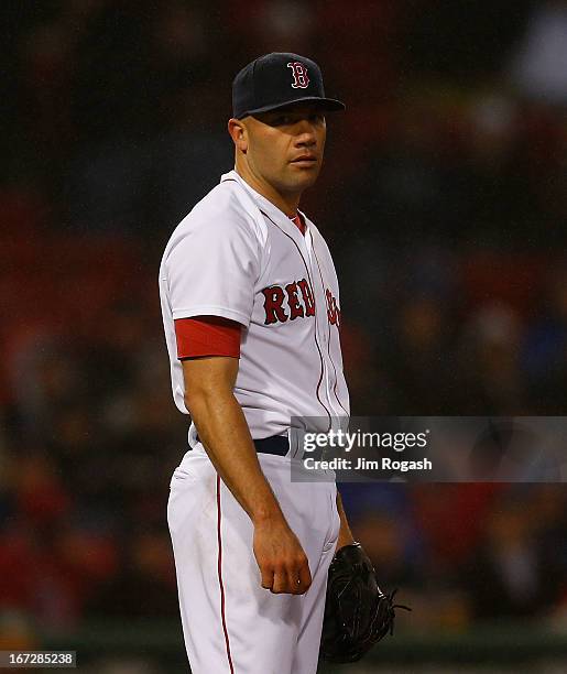 Alfredo Aceves of the Boston Red Sox pauses in the 3rd inning during which he gave up six runs to the Oakland Athletics at Fenway Park on April 23,...
