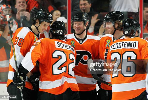 Oliver Lauridsen of the Philadelphia Flyers celebrates scoring his first NHL goal in his game against the Boston Bruins with teammates Luke Schenn,...