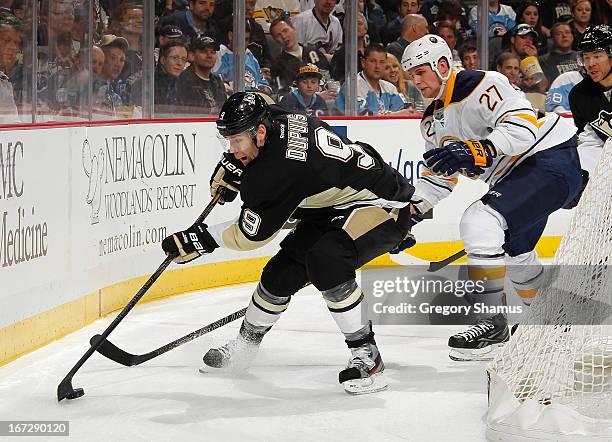 Pascal Dupuis of the Pittsburgh Penguins controls the puck in front of the defense of Adam Pardy of the Buffalo Sabres on April 23, 2013 at Consol...