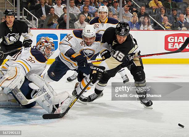 Tanner Glass of the Pittsburgh Penguins has his shot stopped by Ryan Miller of the Buffalo Sabres in front of the defense of Andrej Sekera on April...