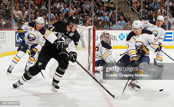 Evgeni Malkin of the Pittsburgh Penguins moves the puck in front of the defense of Mark Pysyk of the Buffalo Sabres on April 23, 2013 at Consol...