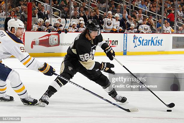 Kris Letang of the Pittsburgh Penguins moves the puck past the defense of Jochen Hecht of the Buffalo Sabres on April 23, 2013 at Consol Energy...