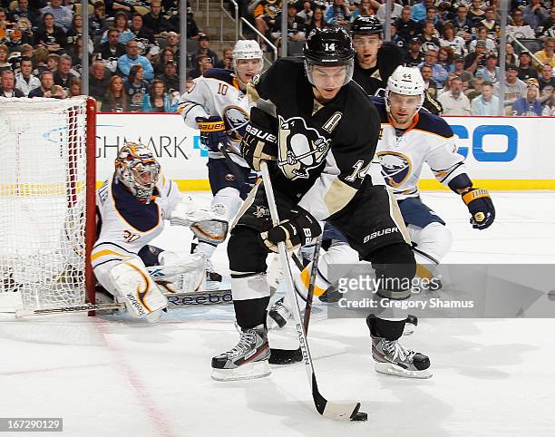 Chris Kunitz of the Pittsburgh Penguins controls the puck in front of Andrej Sekera and Ryan Miller of the Buffalo Sabres on April 23, 2013 at Consol...