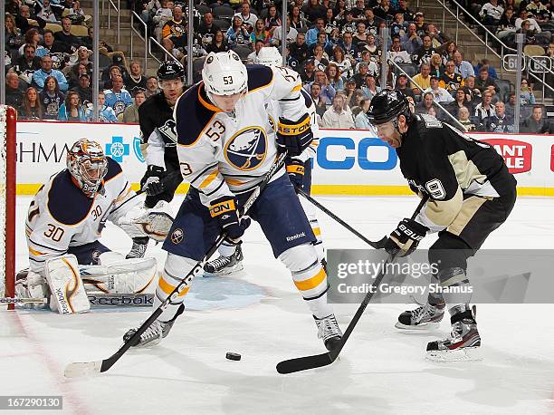 Pascal Dupuis of the Pittsburgh Penguins battles for the loose puck against Mark Pysyk of the Buffalo Sabres on April 23, 2013 at Consol Energy...