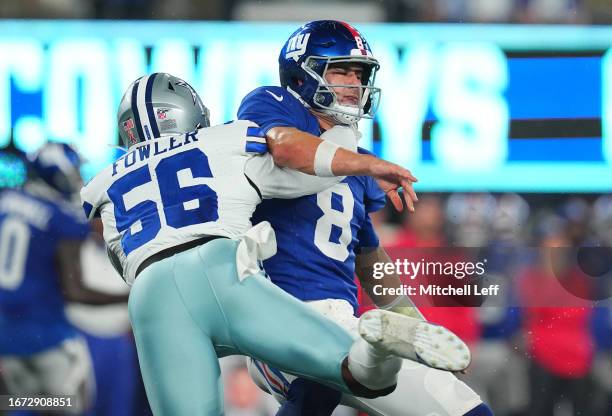 Dante Fowler Jr. #56 of the Dallas Cowboys hits Daniel Jones of the New York Giants during the first quarter at MetLife Stadium on September 10, 2023...