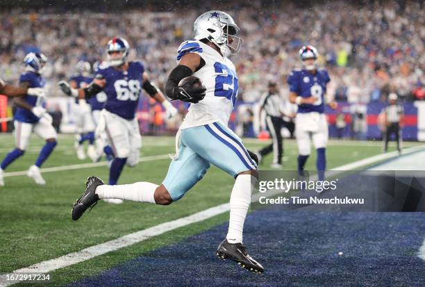 DaRon Bland of the Dallas Cowboys returns an interception for a touchdown during the first quarter against the New York Giants at MetLife Stadium on...