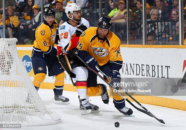 Hal Gill of the Nashville Predators skates against Akim Aliu of the Calgary Flames during an NHL game at the Bridgestone Arena on April 23, 2013 in...