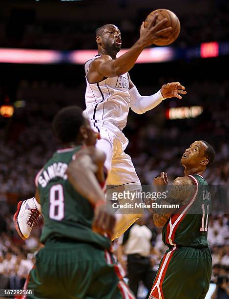 Dwyane Wade of the Miami Heat drives past Monta Ellis of the Milwaukee Bucks during Game 2 of the Eastern Conference Quarterfinals of the 2013 NBA...