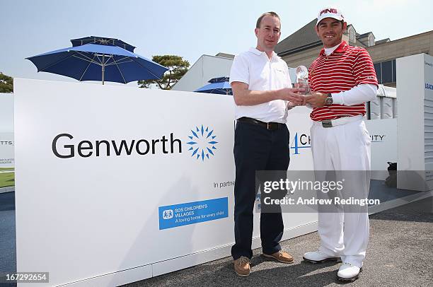 Louis Oosthuizen of South Africa is presented with the 2012 Genworth Performance Award by Kevin Fleming, Vice President Genworth New Markets, during...