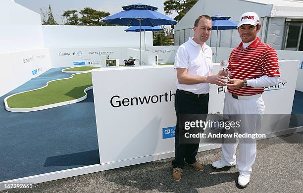 Louis Oosthuizen of South Africa is presented with the 2012 Genworth Performance Award by Kevin Fleming, Vice President Genworth New Markets, during...
