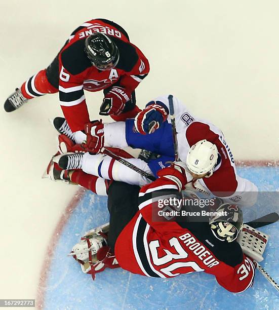 Brandon Prust of the Montreal Canadiens runs into Martin Brodeur of the New Jersey Devils as Andy Greene helps defend at the Prudential Center on...