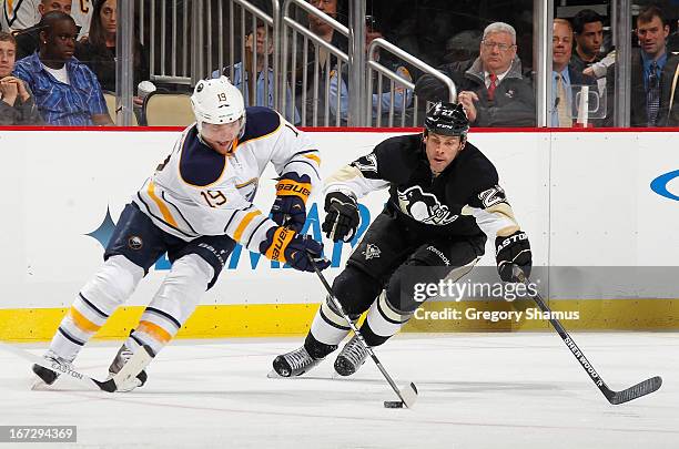 Cody Hodgson of the Buffalo Sabres moves the puck in front of Craig Adams of the Pittsburgh Penguins on April 23, 2013 at Consol Energy Center in...