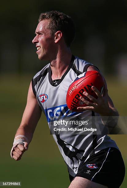 Captain Nick Maxwell, recovering from a wrist injury, handles the ball with only his right hand during a Collingwood Magpies AFL training session at...