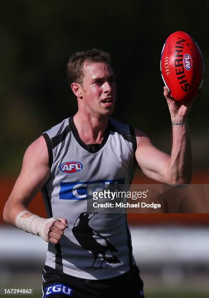 Captain Nick Maxwell, recovering from a wrist injury, handles the ball with only his right hand during a Collingwood Magpies AFL training session at...