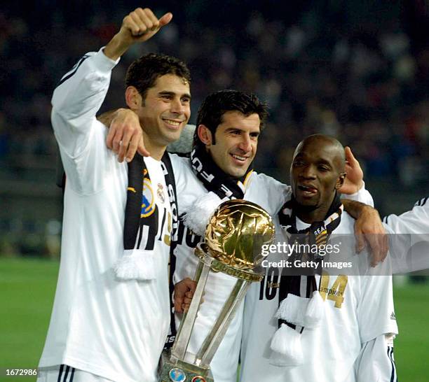 Fernando Hierro, Luis Figo and Claude Makelele of Real Madrid celebrate with the trophy following victory in the Toyota Intercontinental Cup between...