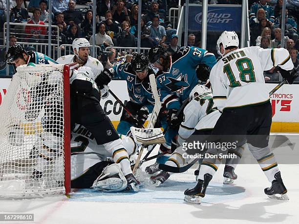 Adam Burish and Scott Hannan of the San Jose Sharks look for a rebound against Reilly Smith, Tom Wandell and Kari Lehtonen of the Dallas Stars during...