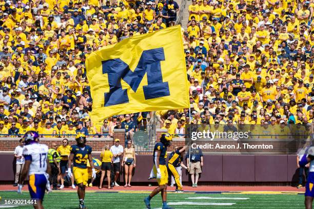 Michigan flag is seen during the first half of a college football game between the Michigan Wolverines and the East Carolina Pirates at Michigan...