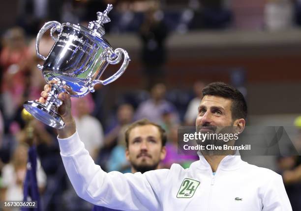 Novak Djokovic of Serbia holds aloft his winners trophy after defeating Daniil Medvedev of Russia during their Men's Singles Final match on Day...