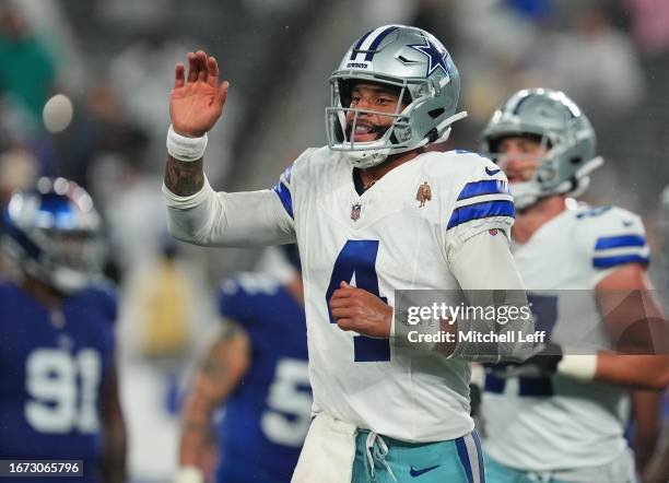 Dak Prescott of the Dallas Cowboys reacts after a touchdown run by KaVontae Turpin during the fourth quarter against the New York Giants at MetLife...