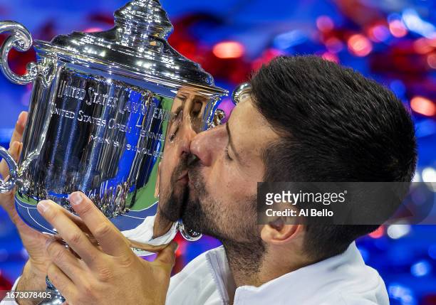 Novak Djokovic of Serbia kisses the winners trophy after defeating Daniil Medvedev of Russia during their Men's Singles Final match on Day Fourteen...