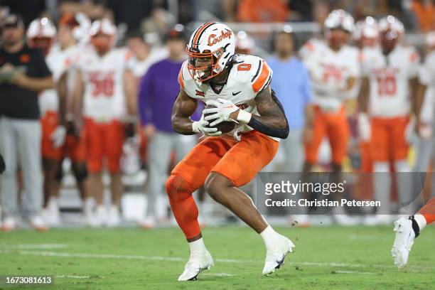 Running back Ollie Gordon II of the Oklahoma State Cowboys rushes the football against the Arizona State Sun Devils during the second half of the...