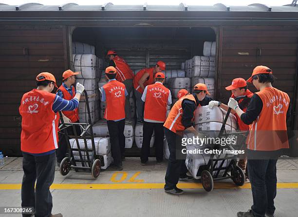 Rescuers unload relief supplies from a train at Xinjin railway station on April 23, 2013 in Xinjin County, China. A powerful earthquake struck the...