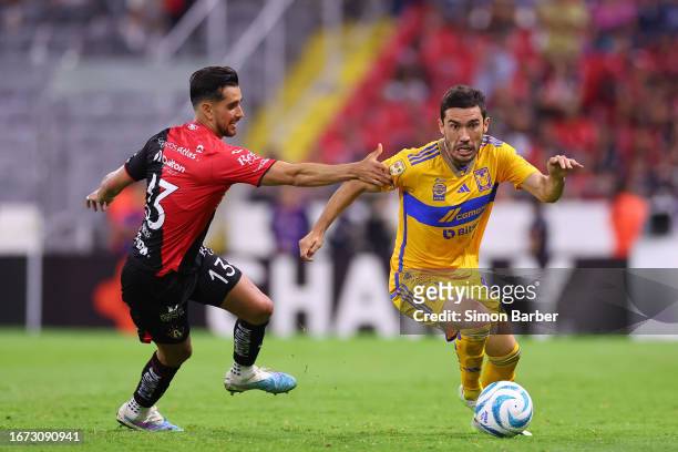 Juan Vigon of Tigres battles for possession with Gaddi Aguirre of Atlas during the 8th round match between Atlas and Tigres UANL as part of the...