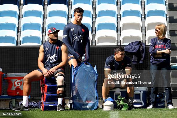 Daniel Tupou, Joseph-Aukuso Suaalii and Joseph Manu of the Roosters look on from the sidelines during a Sydney Roosters NRL training session at...