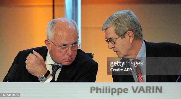 French carmaker PSA Peugeot Citroen head Philippe Varin talks with Chairman of the Supervisory Board Thierry Peugeot during the group's shareholders...