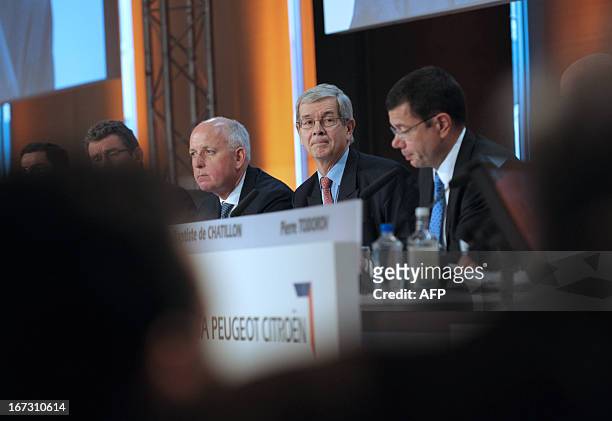 French carmaker PSA Peugeot Citroen head Philippe Varin flanked by Chairman of the Supervisory Board Thierry Peugeot and CFO Jean-Baptiste de...